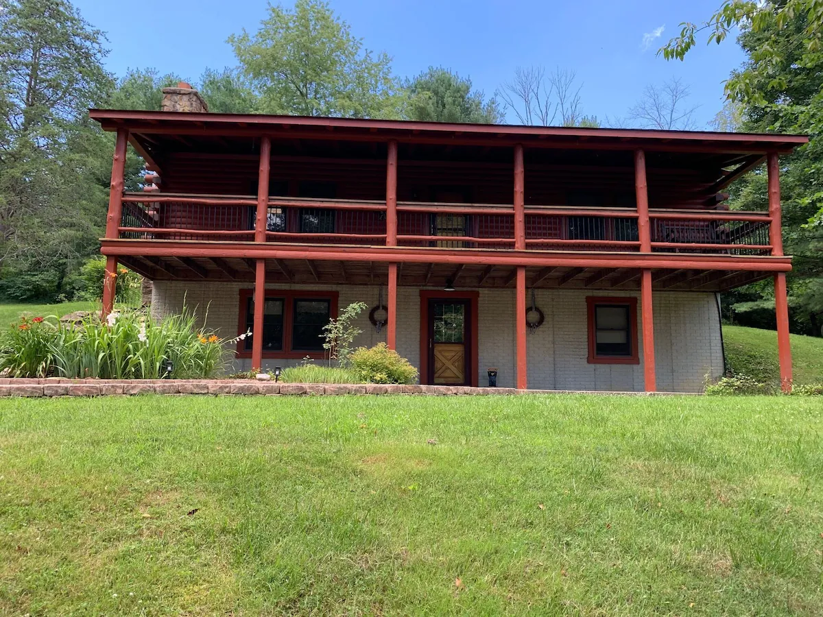 Cabin porch railings and log siding up close.