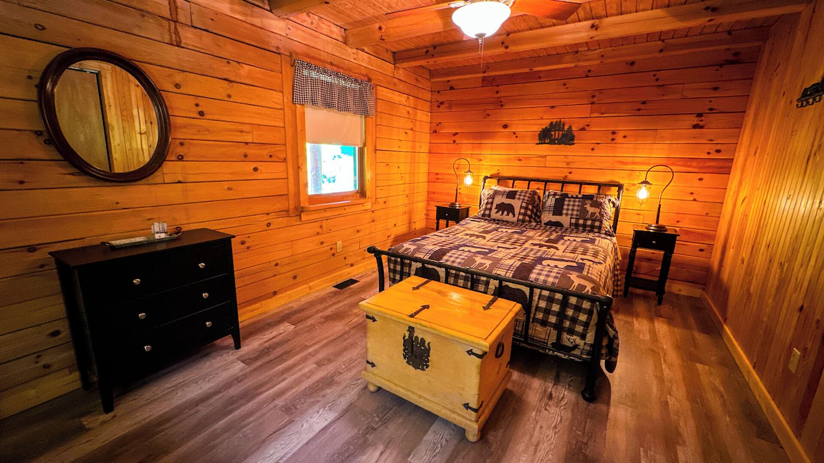 Second bedroom with a queen bed and a cedar chest at the foot of the bed.